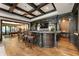 Entertainers basement with custom bar, hardwood floors and paneled walls at 4874 Kettle River Pt, Suwanee, GA 30024