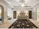 Bedroom with ornate bed frame, neutral walls, and decorative rug at 4874 Kettle River Pt, Suwanee, GA 30024