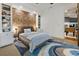 Bedroom featuring a brick accent wall and built-in shelving at 4874 Kettle River Pt, Suwanee, GA 30024