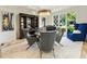 Dining room featuring a modern chandelier, stylish decor, and large windows for natural light at 4874 Kettle River Pt, Suwanee, GA 30024