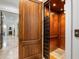 Interior elevator featuring wood paneling and custom lighting at 4874 Kettle River Pt, Suwanee, GA 30024