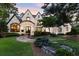 Charming two-story home with stone and brick accents, arched entry, and professional landscaping at 4874 Kettle River Pt, Suwanee, GA 30024