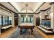 Spacious game room with pool table, seating area, stylish lighting, and dark wood trim throughout at 4874 Kettle River Pt, Suwanee, GA 30024