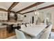 Open kitchen featuring a large center island, pendant lighting, exposed brick, and a long dining table at 4874 Kettle River Pt, Suwanee, GA 30024