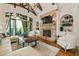 Elegant living room with stone fireplace, hardwood floors, and french doors to outdoor space at 4874 Kettle River Pt, Suwanee, GA 30024