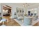 Elegant living room with an open floor plan, view to the kitchen, and modern decor at 4874 Kettle River Pt, Suwanee, GA 30024