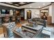 Open living room featuring a bar with seating, elegant furniture, arched doorways, and recessed lighting at 4874 Kettle River Pt, Suwanee, GA 30024