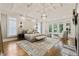 Spacious main bedroom with tray ceiling, chandelier, large windows, and fireplace at 4874 Kettle River Pt, Suwanee, GA 30024