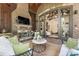 Inviting outdoor living space with brick fireplace, TV, and comfortable seating at 4874 Kettle River Pt, Suwanee, GA 30024