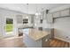 Modern kitchen with gray cabinets, granite counters and island at 11827 Rizvan Pl, Covington, GA 30014