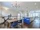 Open concept dining area with a wooden table and blue chairs, Peloton bike visible at 2032 Holtz Ln, Atlanta, GA 30318