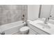 Bathroom with a tub, toilet and white vanity at 2709 Richmond Row Dr, Suwanee, GA 30024