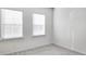 Spacious bedroom with two windows and grey carpet at 2709 Richmond Row Dr, Suwanee, GA 30024