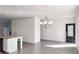 Bright dining area with hardwood floors, chandelier, and access to exterior at 2709 Richmond Row Dr, Suwanee, GA 30024