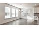 Dining area with hardwood floors and a chandelier, adjacent to kitchen at 2709 Richmond Row Dr, Suwanee, GA 30024