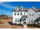 Two-story townhome with gray and white siding, a front porch, and landscaping at 2709 Richmond Row Dr, Suwanee, GA 30024