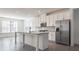 Modern kitchen with island and stainless steel appliances at 2709 Richmond Row Dr, Suwanee, GA 30024