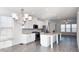 Open concept kitchen with white cabinets, granite countertops and island at 2709 Richmond Row Dr, Suwanee, GA 30024