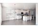Bright kitchen features white cabinets, granite island, and hardwood floors at 2709 Richmond Row Dr, Suwanee, GA 30024