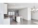 Open concept kitchen with island, stainless steel appliances, and hardwood floors at 2709 Richmond Row Dr, Suwanee, GA 30024