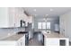 Open concept kitchen with white cabinets, granite countertops, and stainless steel appliances at 2709 Richmond Row Dr, Suwanee, GA 30024