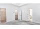 Main bedroom with carpet, walk-in closet, and bath access at 2709 Richmond Row Dr, Suwanee, GA 30024