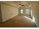 Large main bedroom with ceiling fan and two windows at 4010 Peachtree Farms Rd, Rex, GA 30273