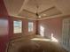 Spacious carpeted bedroom with two windows and ceiling fan at 4010 Peachtree Farms Rd, Rex, GA 30273