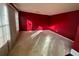 Spacious bedroom with red walls and carpet flooring at 4010 Peachtree Farms Rd, Rex, GA 30273