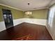 Bright dining room with hardwood floors and a chandelier at 4010 Peachtree Farms Rd, Rex, GA 30273