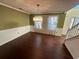 Dining room featuring hardwood floors and a view of the entryway staircase at 4010 Peachtree Farms Rd, Rex, GA 30273