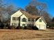 Two-story house with a beige exterior, brown roof, and attached two-car garage at 4010 Peachtree Farms Rd, Rex, GA 30273
