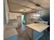 Modern kitchen with white cabinets, quartz countertops, and herringbone flooring at 4010 Peachtree Farms Rd, Rex, GA 30273