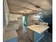 Modern kitchen with white cabinets, quartz countertops, and herringbone flooring at 4010 Peachtree Farms Rd, Rex, GA 30273
