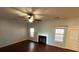 Living room with hardwood floors, fireplace, and ceiling fan at 4010 Peachtree Farms Rd, Rex, GA 30273