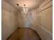 Spacious walk-in closet with chandelier and ample hanging space at 4010 Peachtree Farms Rd, Rex, GA 30273