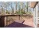 Wooden back deck with railings overlooking the wooded backyard and providing access to the house at 2976 Bay Berry Sw Dr, Marietta, GA 30008