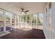 Comfortable screened-in back porch with wood flooring, ceiling fan, and views of a wooded backyard at 2976 Bay Berry Sw Dr, Marietta, GA 30008