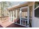 View of the screened in porch and wooden deck from the yard at 2976 Bay Berry Sw Dr, Marietta, GA 30008