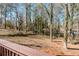 Scenic view of the backyard with mature trees and a gentle slope, as seen from the deck at 2976 Bay Berry Sw Dr, Marietta, GA 30008