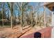 View of the wooded backyard from the wooden deck, showcasing the natural surroundings of the property at 2976 Bay Berry Sw Dr, Marietta, GA 30008
