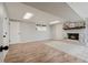 Finished basement showcasing a brick fireplace, wood-look flooring, and neutral paint colors at 2976 Bay Berry Sw Dr, Marietta, GA 30008