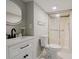 Modern bathroom with a sleek vanity, shower, and stylish round mirror with soft, integrated lighting at 2976 Bay Berry Sw Dr, Marietta, GA 30008