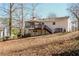 Rear exterior of the home with a deck and a glimpse of the wooded backyard at 2976 Bay Berry Sw Dr, Marietta, GA 30008
