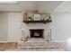 Close-up of a charming whitewashed brick fireplace with a rustic mantel and decorative accents at 2976 Bay Berry Sw Dr, Marietta, GA 30008