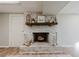 Whitewashed brick fireplace with wood mantel in basement at 2976 Bay Berry Sw Dr, Marietta, GA 30008