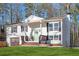 Charming brick home with a welcoming front porch, green door, a pristine lawn, and an attached garage at 2976 Bay Berry Sw Dr, Marietta, GA 30008