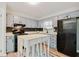 Charming kitchen with grey cabinets, black appliances, modern countertops, and stylish backsplash at 2976 Bay Berry Sw Dr, Marietta, GA 30008