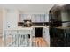 Bright kitchen with grey cabinets, black appliances, modern countertops, and stylish backsplash at 2976 Bay Berry Sw Dr, Marietta, GA 30008
