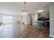 Open concept living room and kitchen with wood-look flooring, modern lighting, and lots of natural light at 2976 Bay Berry Sw Dr, Marietta, GA 30008